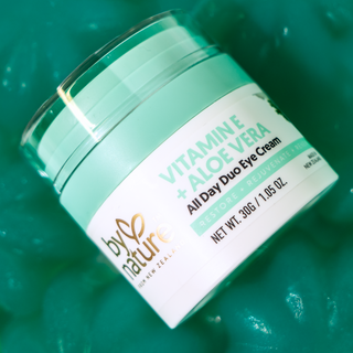 Jar of Vitamin E and Aloe Vera All Day Duo Eye Cream by By Nature on a green background