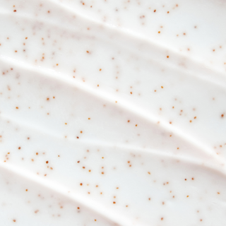 Close-up of a smooth, light-colored surface with small brown specks.